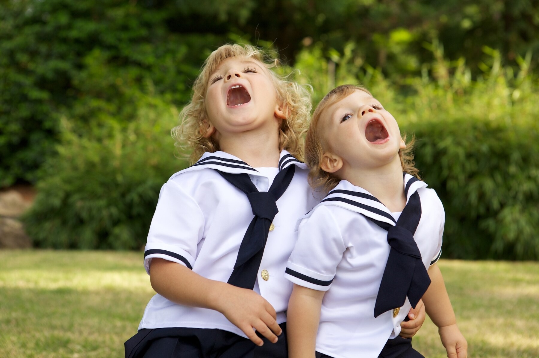 kids-with-their-mouths-open-field-surrounded-by-greenery-sunlight_181624-13920